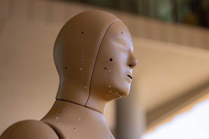 A manikin's head drips sweat